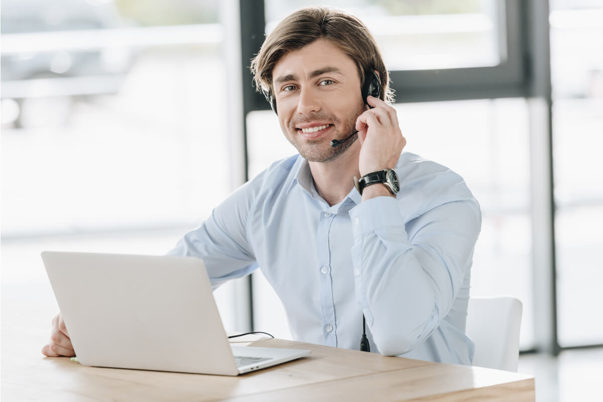 smiling-call-center-worker-with-laptop-looking-at-2021-08-29-22-51-33-utc.jpg